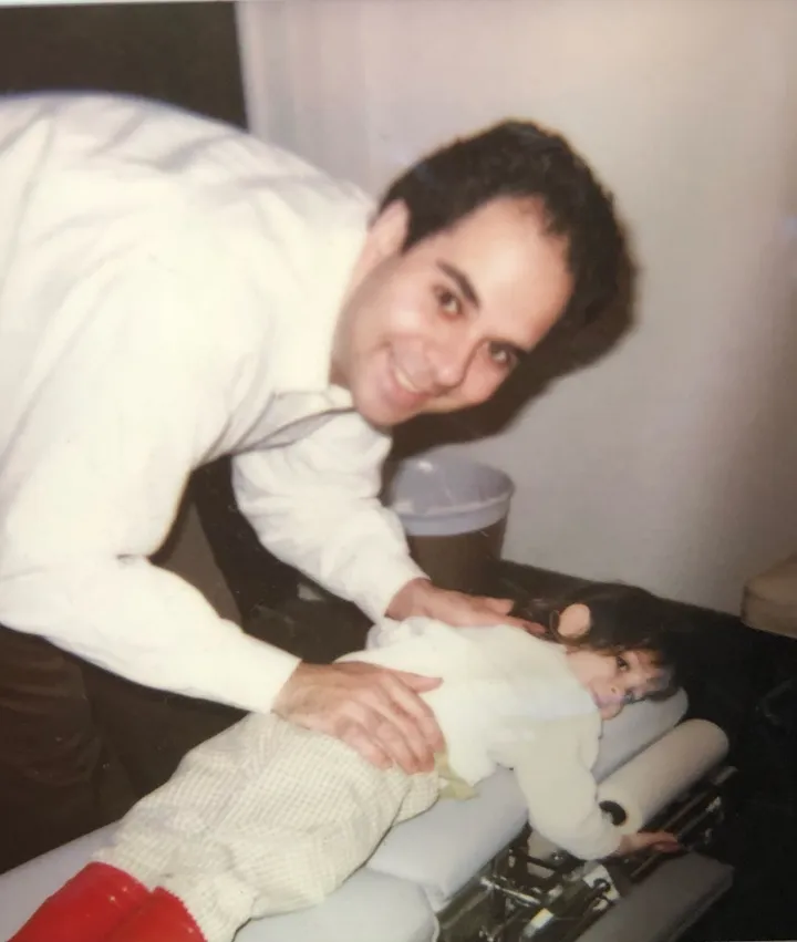 Dr. Sam during an early hands-on chiropractic visit